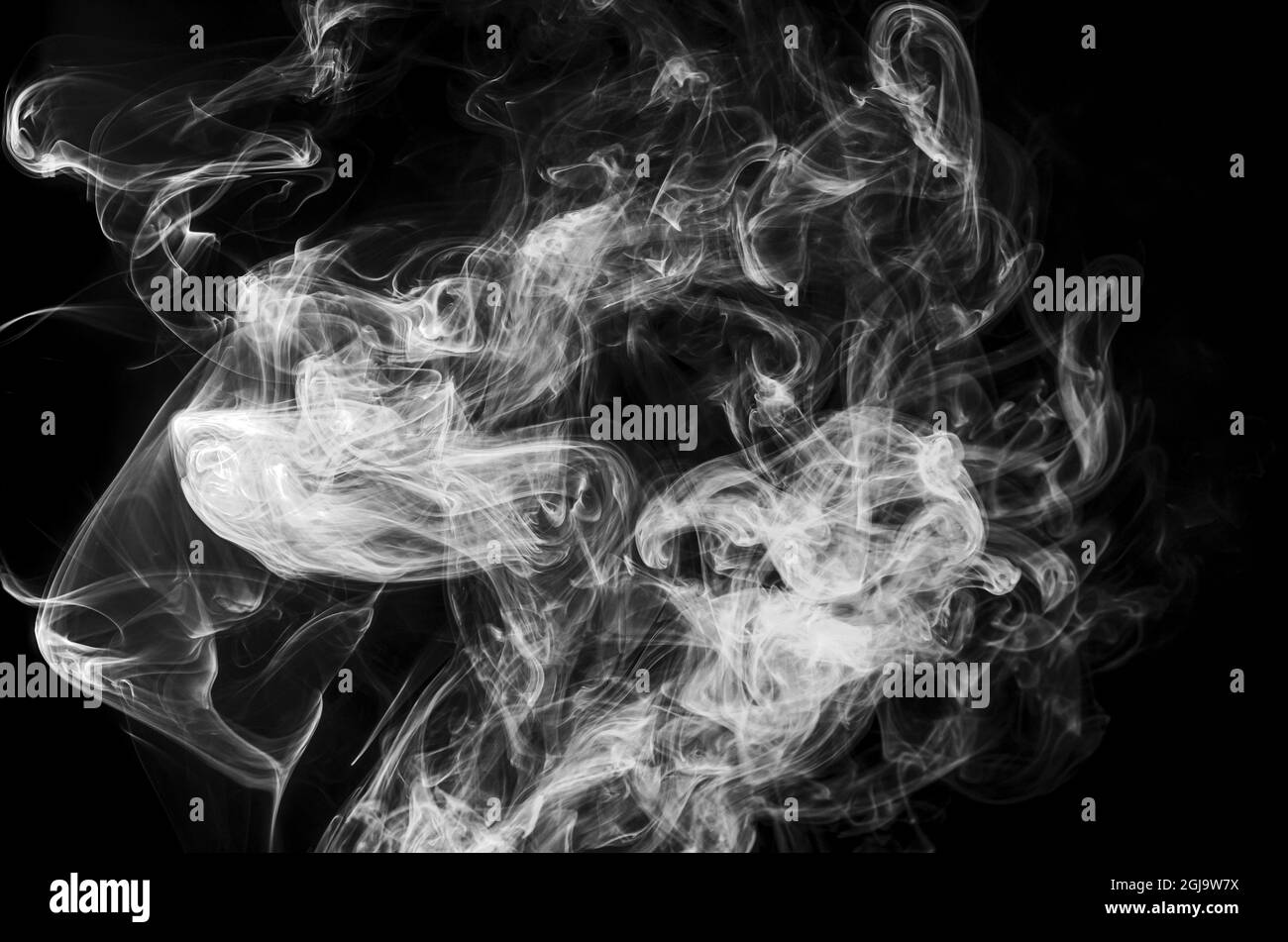 White curves of smoke waves in the dark, isolated on black background. Fume cloud from cigarette, steam, dry ice in dynamics for decor, design Stock Photo