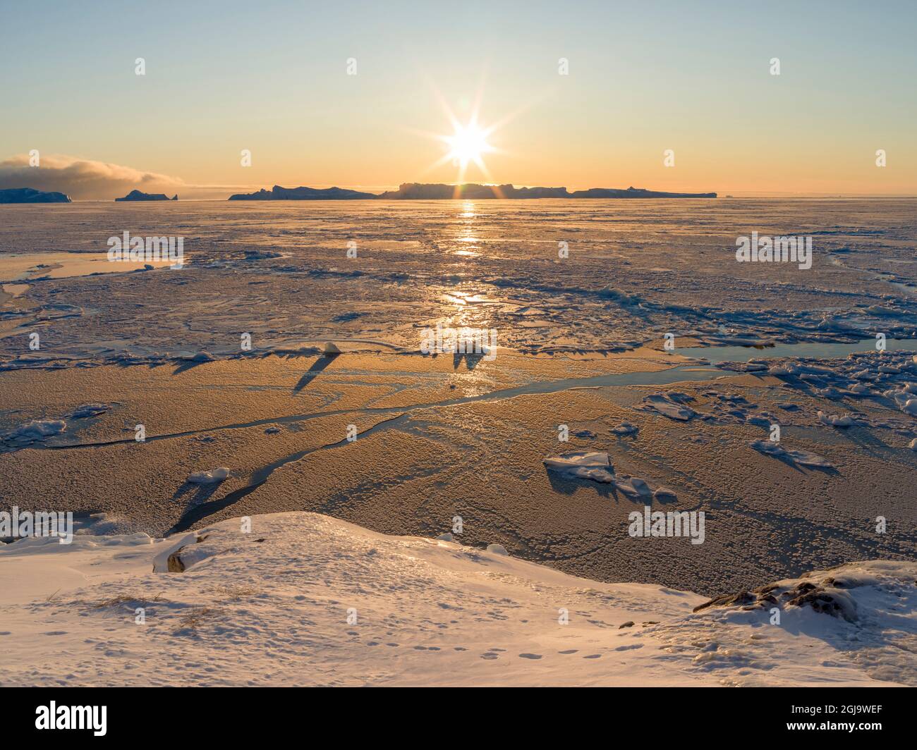 Sunset during winter at the Ilulissat Fjord, located in the Disko Bay ...
