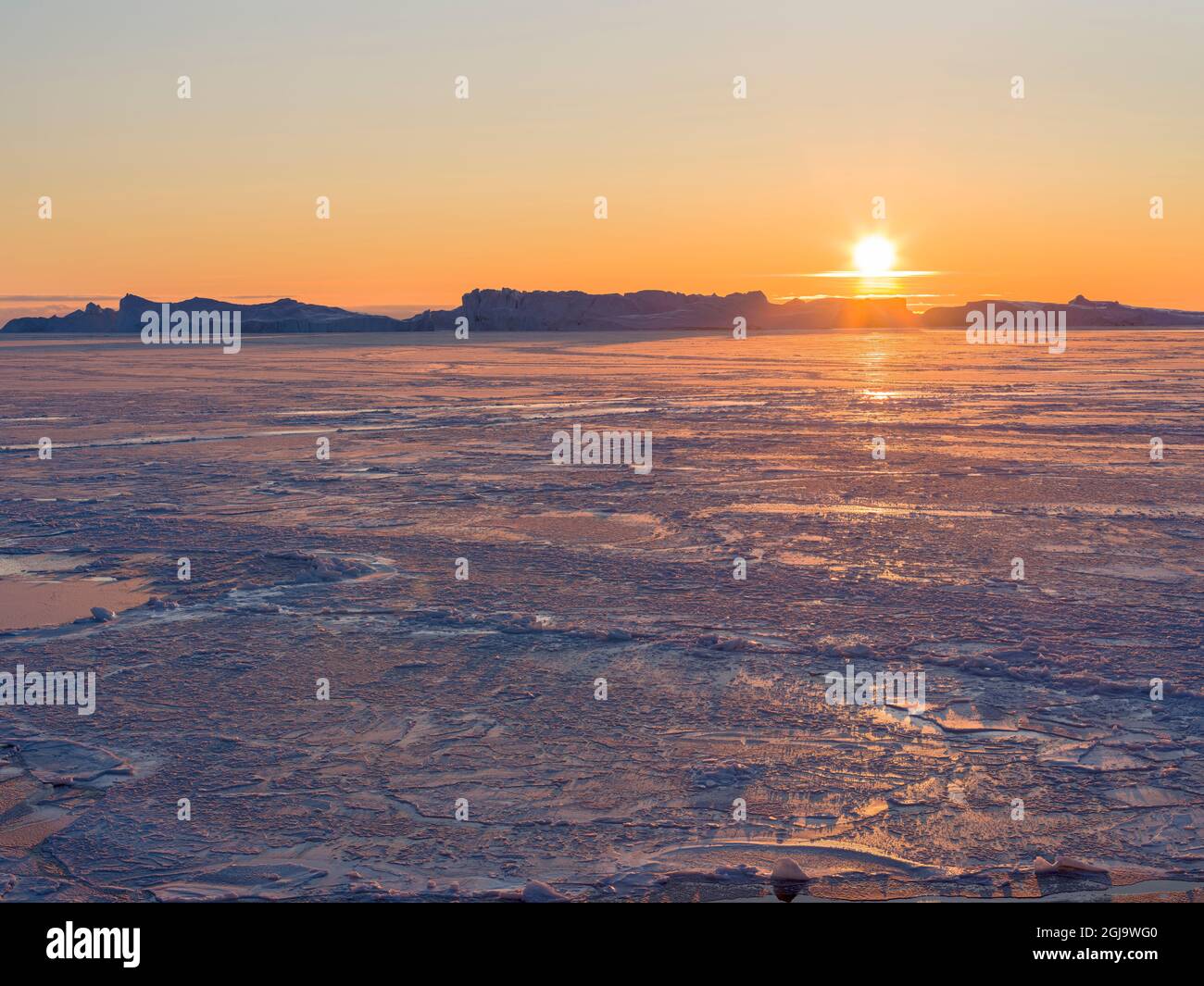 Sunset during winter at the Ilulissat Fjord, located in the Disko Bay ...