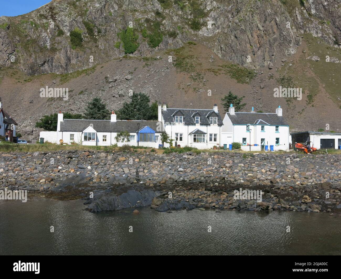 The craggy mountain backdrop dwarfs white cottages in the village of