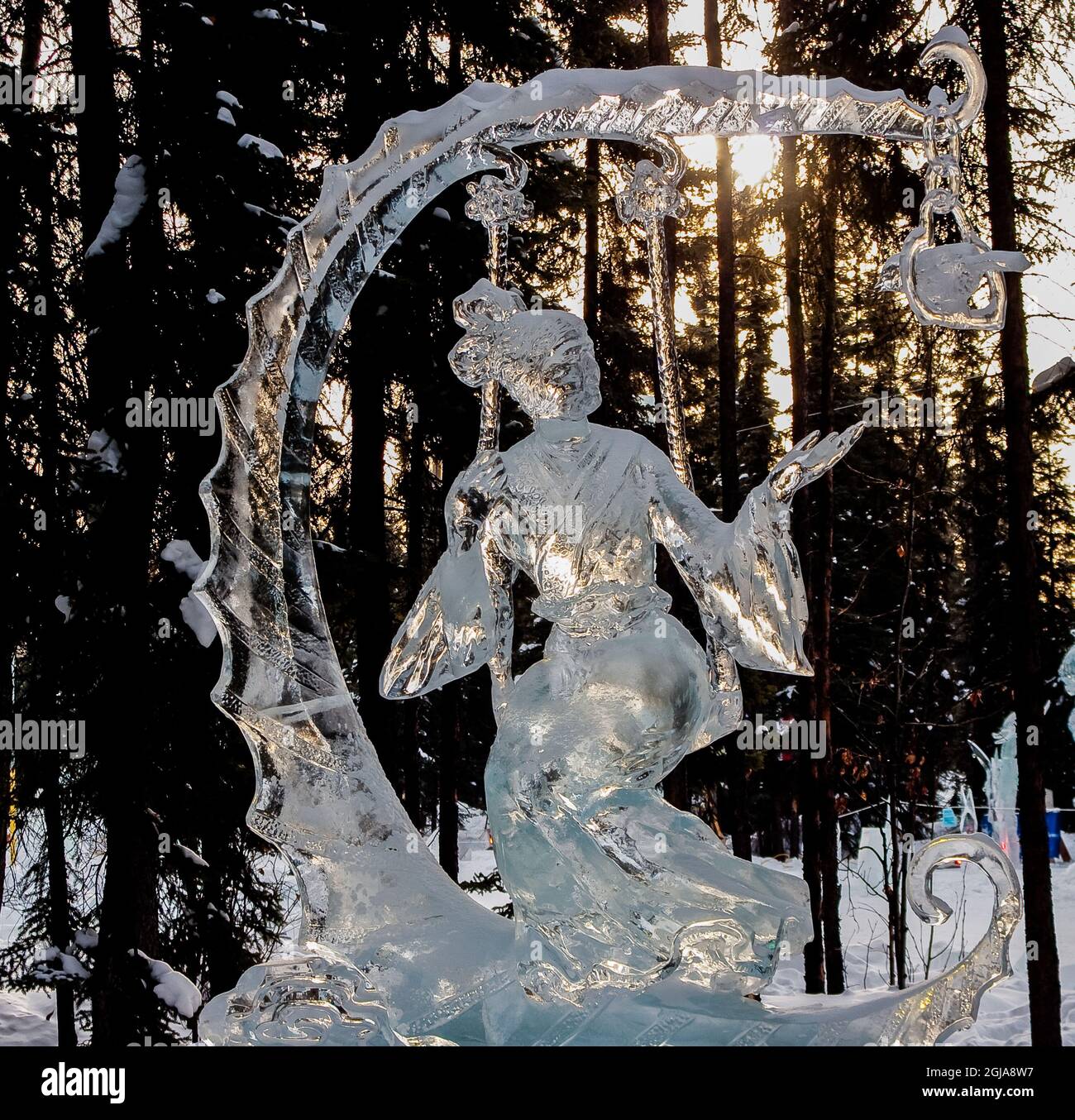 Victorian Dressed Woman on Swing Ice Carving at The Ice Art Championship, Fairbanks, Alaska, USA Stock Photo