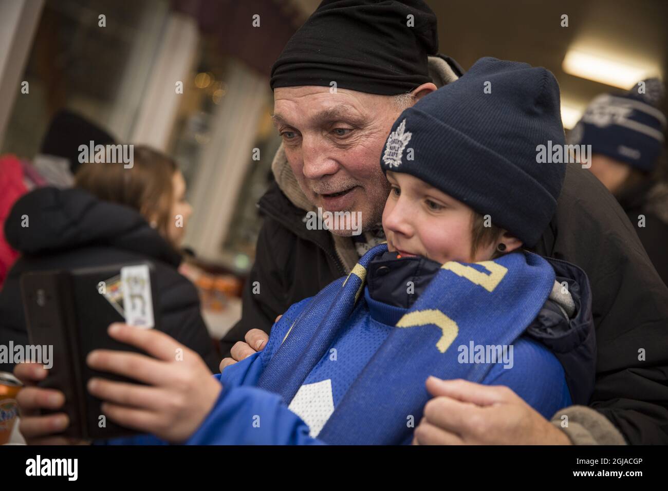 KIRUNA 2016-12-03 Tiger Williams, former Toronto Maple Leafs ice hockey player with a young Toronto Maple Leafs fan during a ceremony for Swedish ice hockey player Borje Salming at Matojarvi ice rink in Kiruna, Sweden December 3, 2016. A banner with Borje Salming's Toronto Maple Leafs number 21 was raised prior to a local hockey match between Kiruna AIF and Malmbergts AIF. Photo Fredric Alm / TT kod 200  Stock Photo