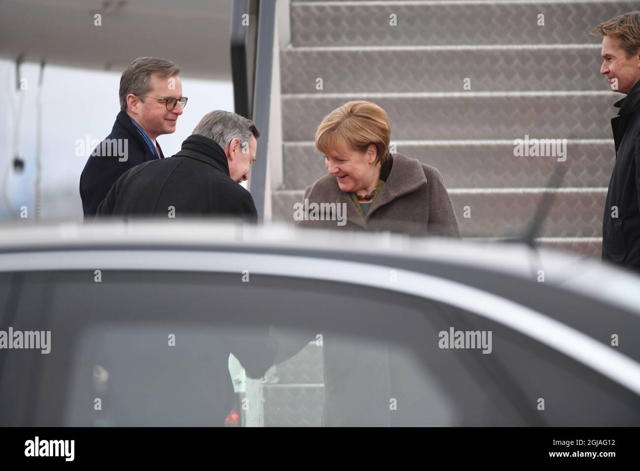 German Chancellor Angela Merkel (2ndR) is greeted by Mikael Damberg, Sweden's Minister for Enterprise and Innovation (L) and Germany's ambassdor to Sweden Hans-Juergen Heimsoeth (2dL) upon arrival to Arlanda Airport outside Stockholm, Sweden on Jan. 31, 2017. Merkel is on a one-day official visit to Sweden. Photo: Fredrik Sandberg / TT / code 10080  Stock Photo