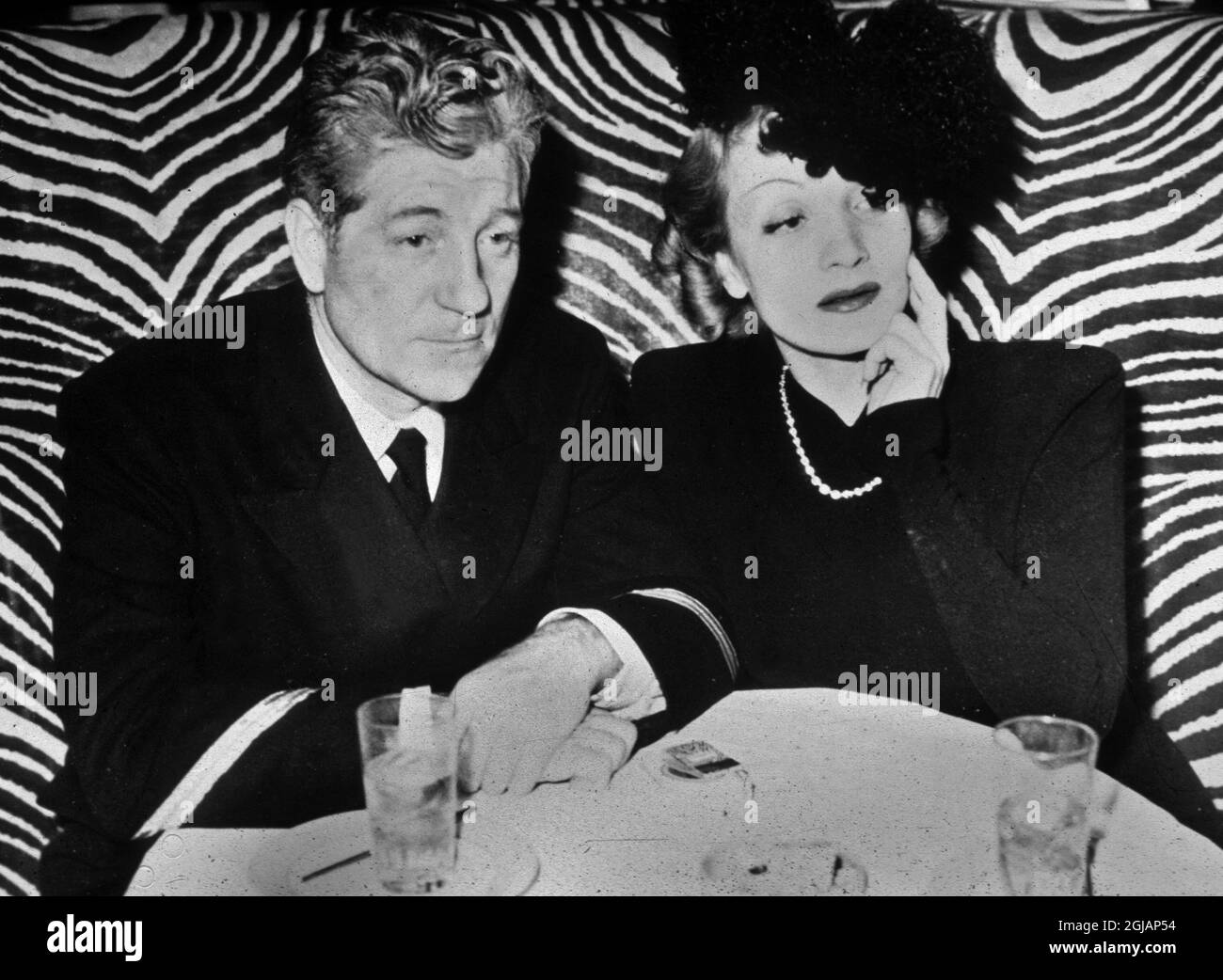 1706546 Marlene Dietrich and Jean Gabin (at that time French navy officer) at El Morocco New York nightclub c. 1944 during the war; (add.info.: Marlene Dietrich and Jean Gabin (at that time french navy officer) at El Morocco New York nightclub c. 1944 during the war);  it is possible that some works by this artist may be protected by third party rights in some territories. Stock Photo