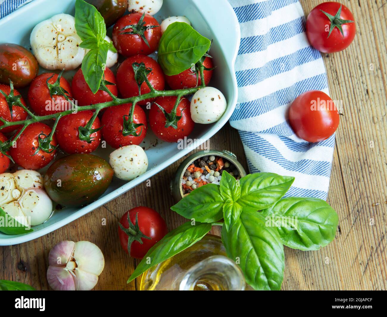 Fresh vegetable tomato, basil, mozzarella cheese for baking in the oven