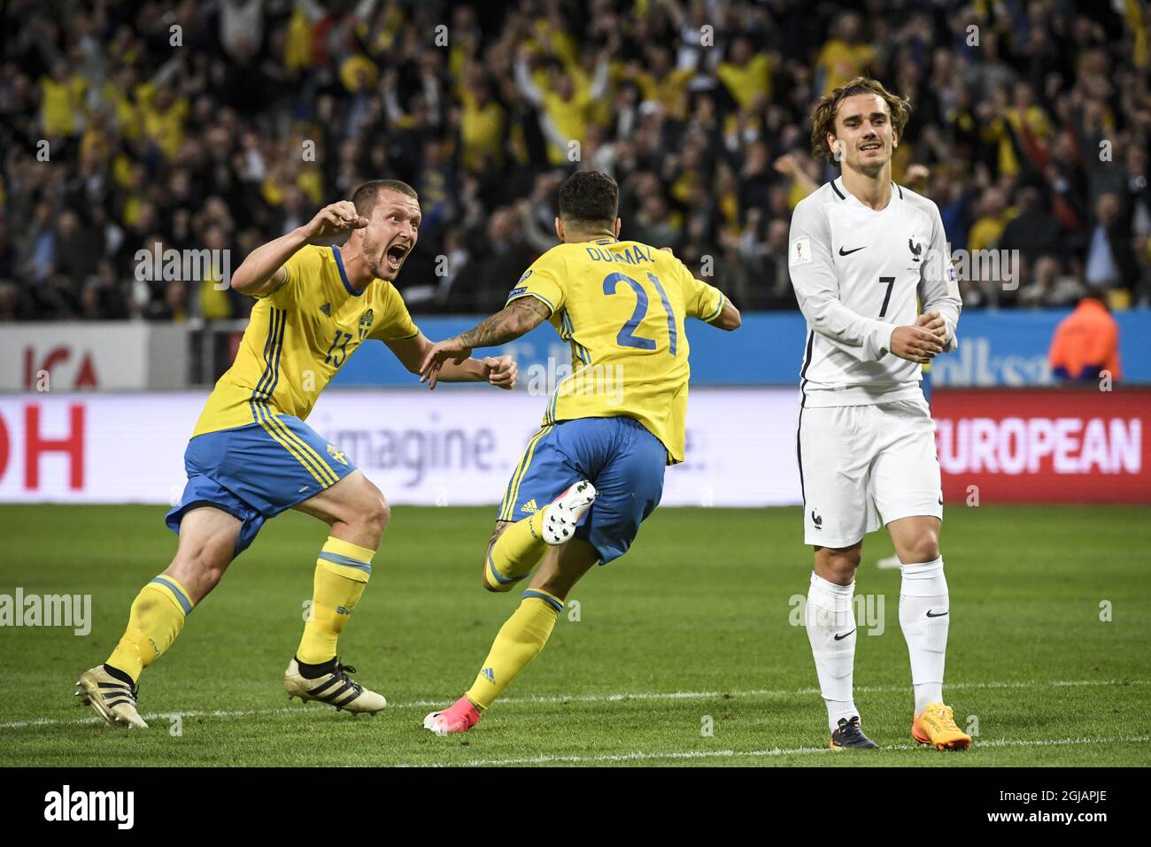 Sweden's Jimmy Durmaz C) celebrates scoring with teammate Jakob Johansson (L) as France's Antoine Griezmann (R) looks on during the FIFA World Cup 2018 group A qualifying soccer match between Sweden and France on June 9, 2017 at Friends Arena in Solna, Stockholm. Photo Janerik Henriksson / TT / kod 10010  Stock Photo