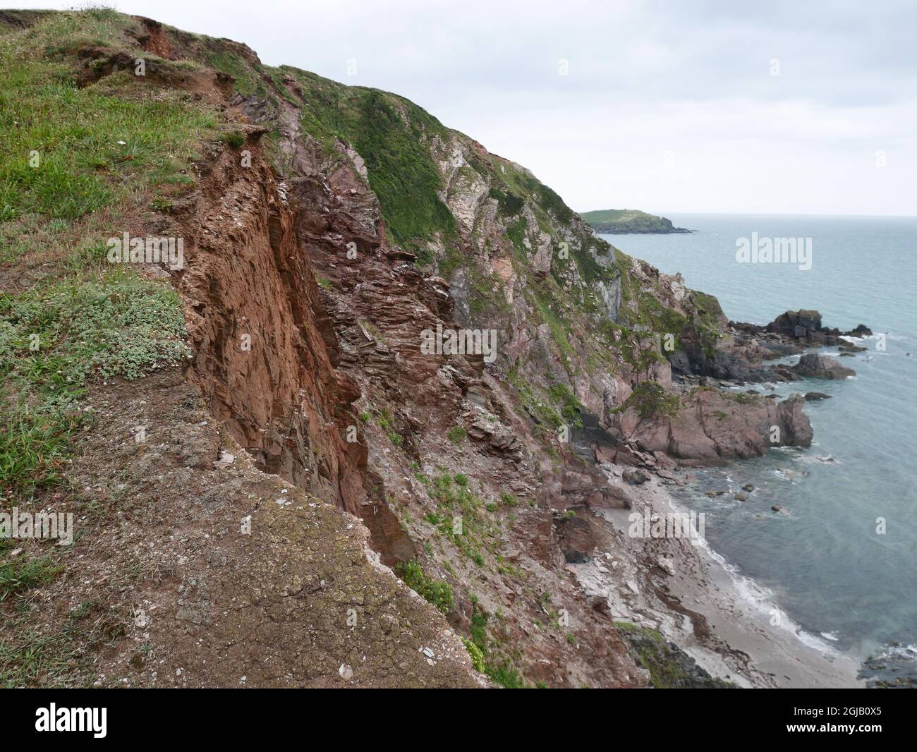 Unstable cliff edge on the South West Coast path near Challaborough, South Hams, Devon. Stock Photo
