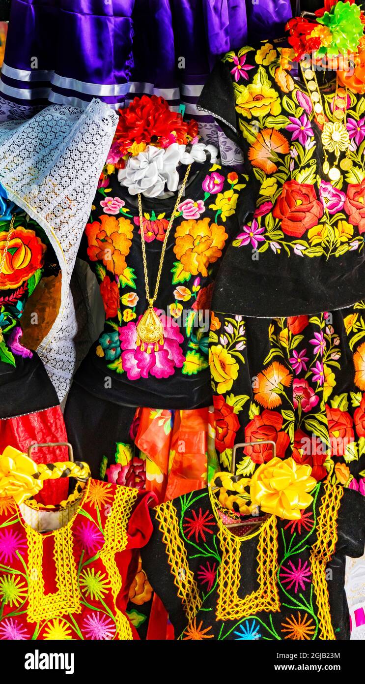 Colorful Mexican dresses and gold jewelry cross necklaces, Oaxaca