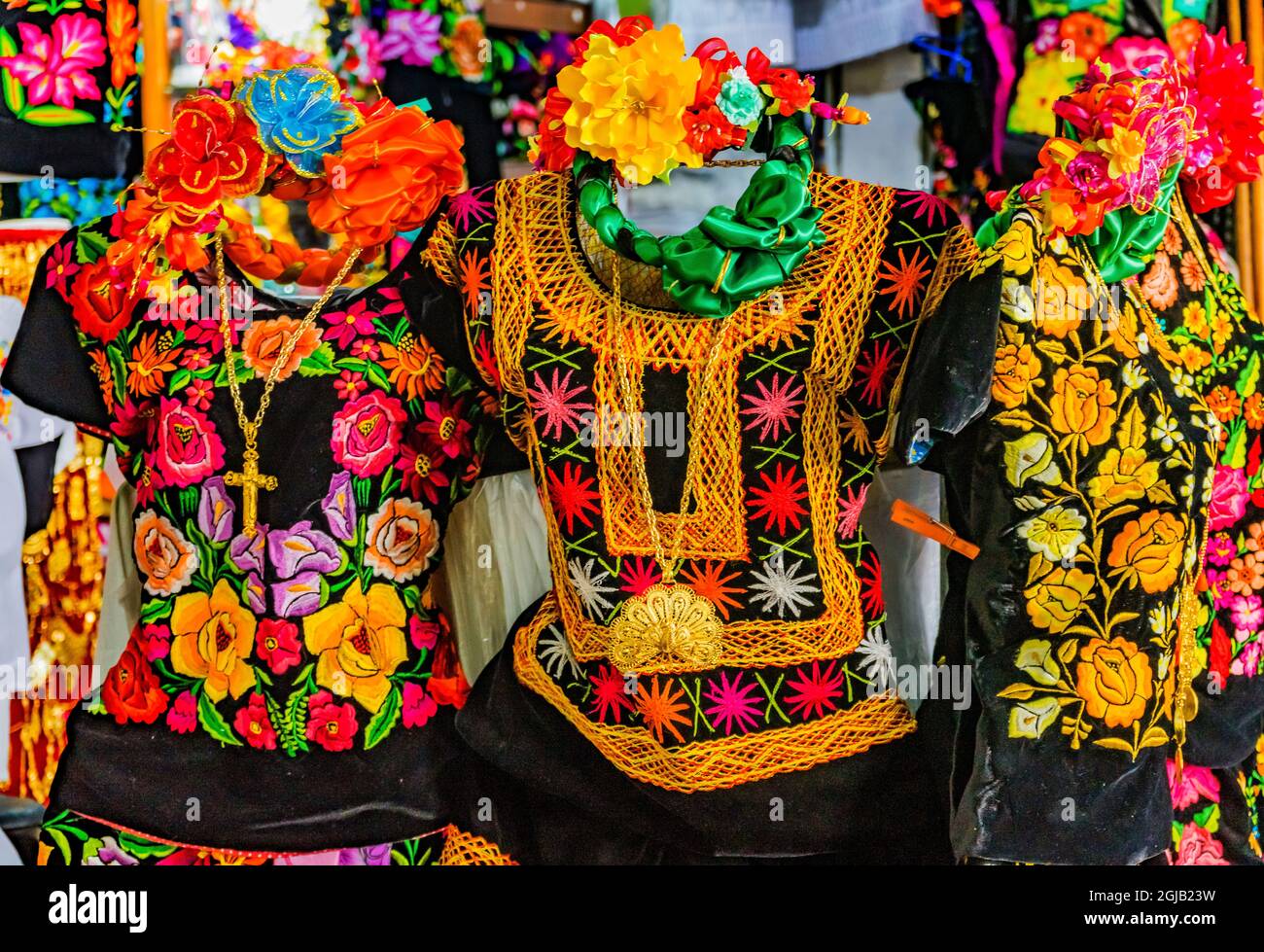 Colorful Mexican dresses and gold jewelry cross necklaces, Oaxaca