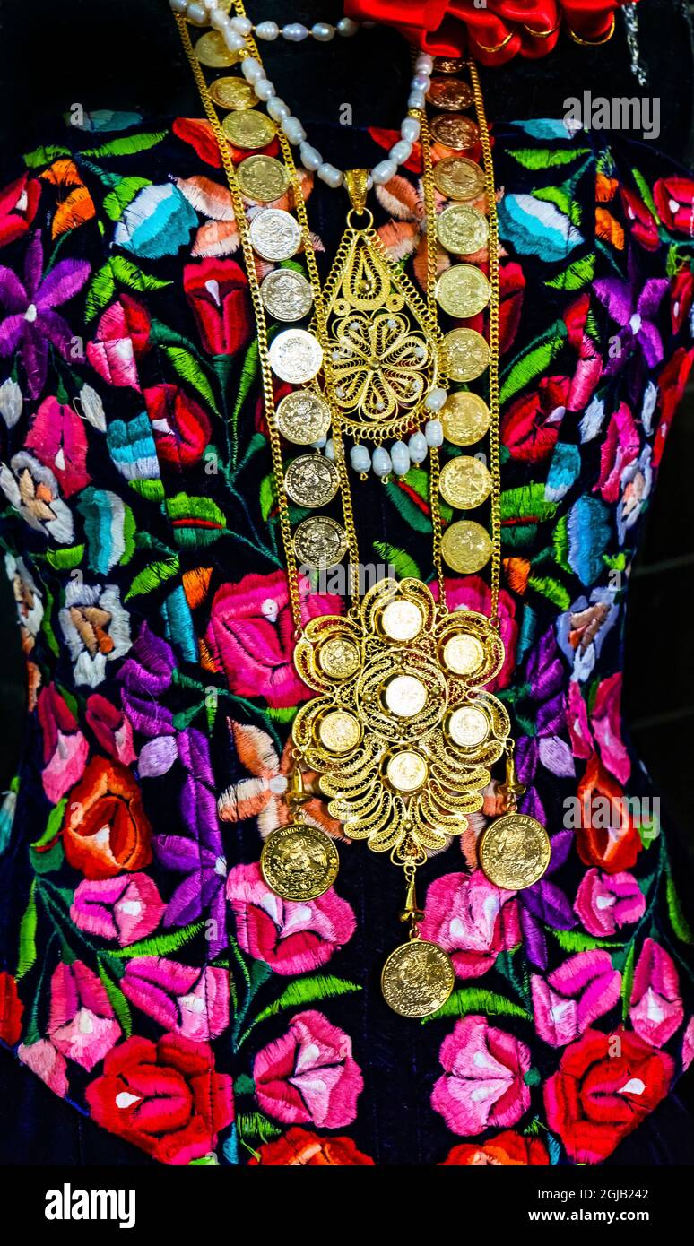Colorful Mexican dresses and gold jewelry cross necklaces, Oaxaca