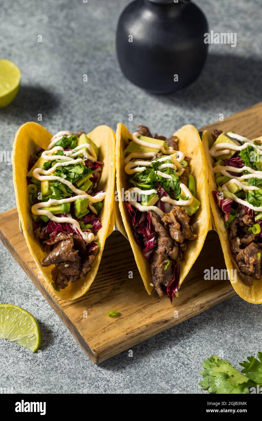 Homemade Korean Beef Bulgogi Tacos with Avocado and Cabbage Stock Photo