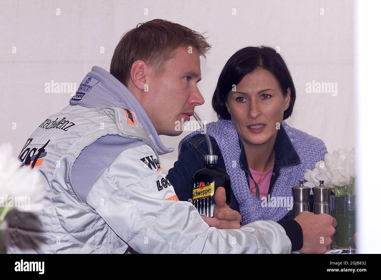 Mika Hakkinen (l) and his wife Erja (r) talking over lunch Stock Photo