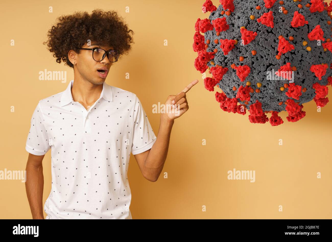 Amazed man with glasses indicates something with hand Stock Photo