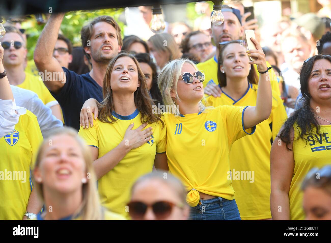 Swedish soccer fans take a selfie as they watch Sweden play against Mexico during the Russia 2018 World Cup Group F soccer match on a big screen outdoors at Norra Bantorget in central Stockholm, Sweden, on June 27, 2018. Photo: Fredrik Sandberg / TT / code 10080  Stock Photo