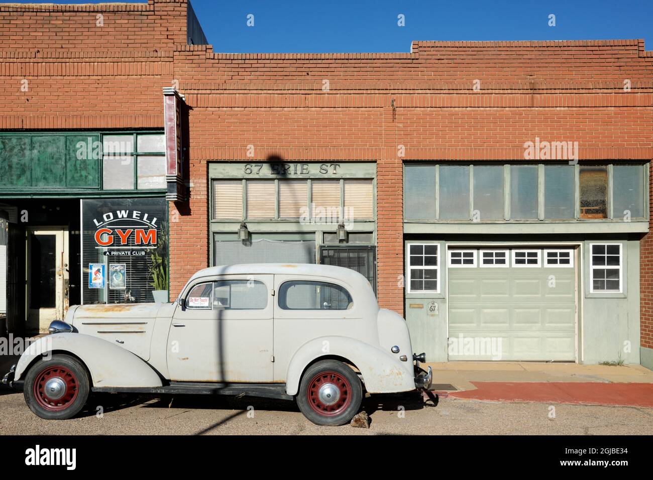 Lowell, Arizona. Old car parked in front of a brick building