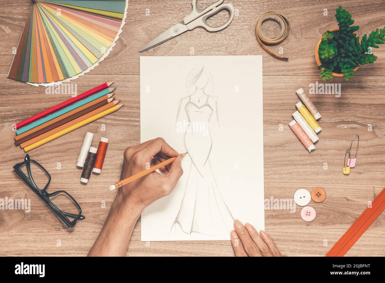 Close-up of designer drawing a fashion sketch Stock Photo - Alamy