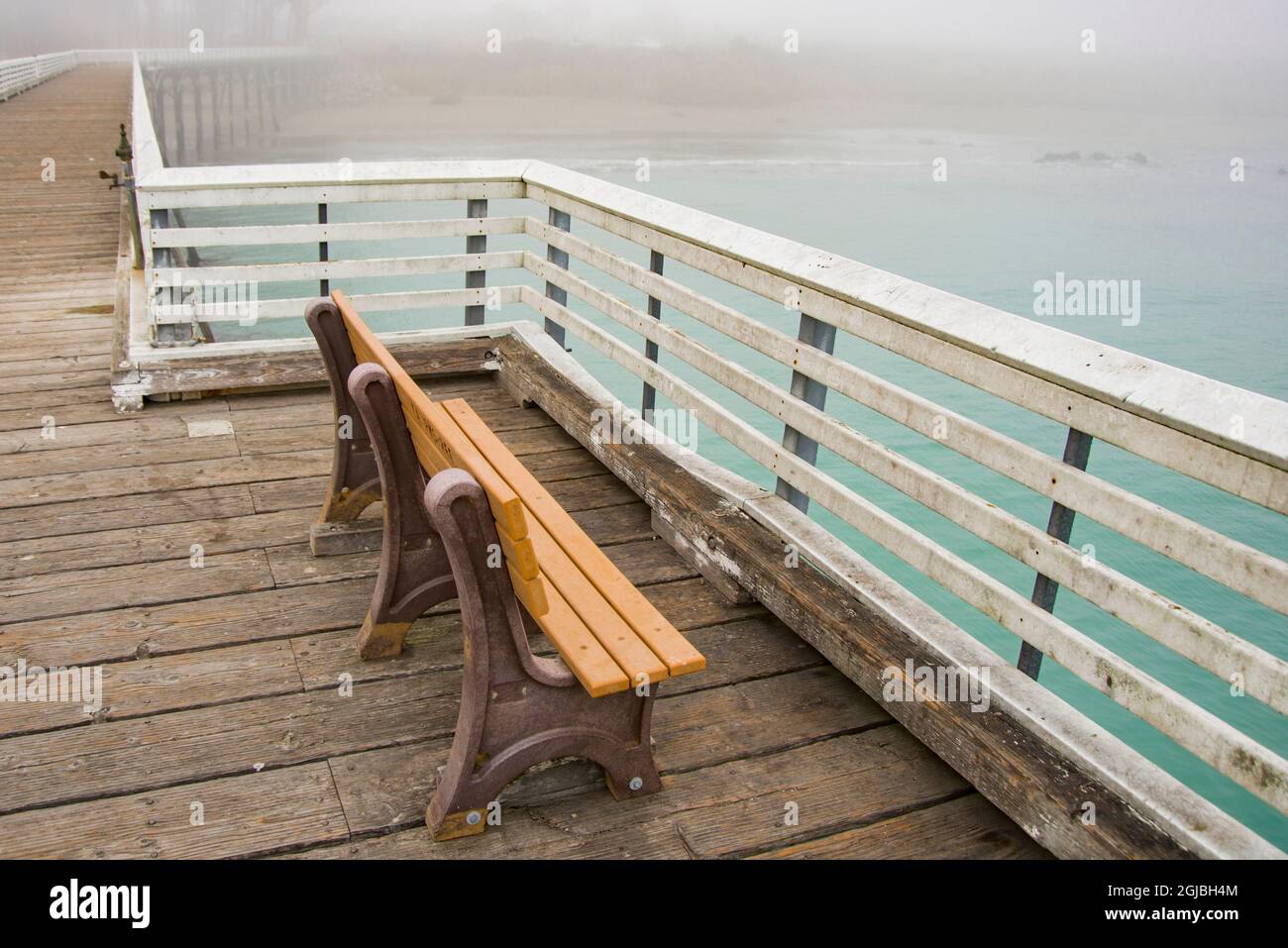 USA, California. San Simeon, empty bench on wharf. Stock Photo