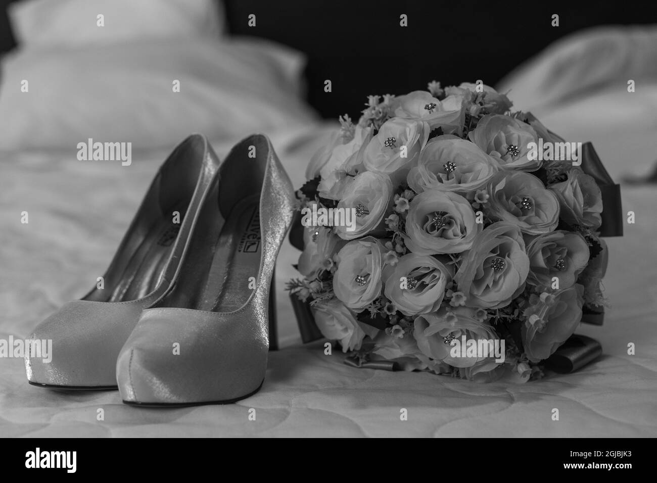 Grayscale of woman shoes near the flowers Stock Photo