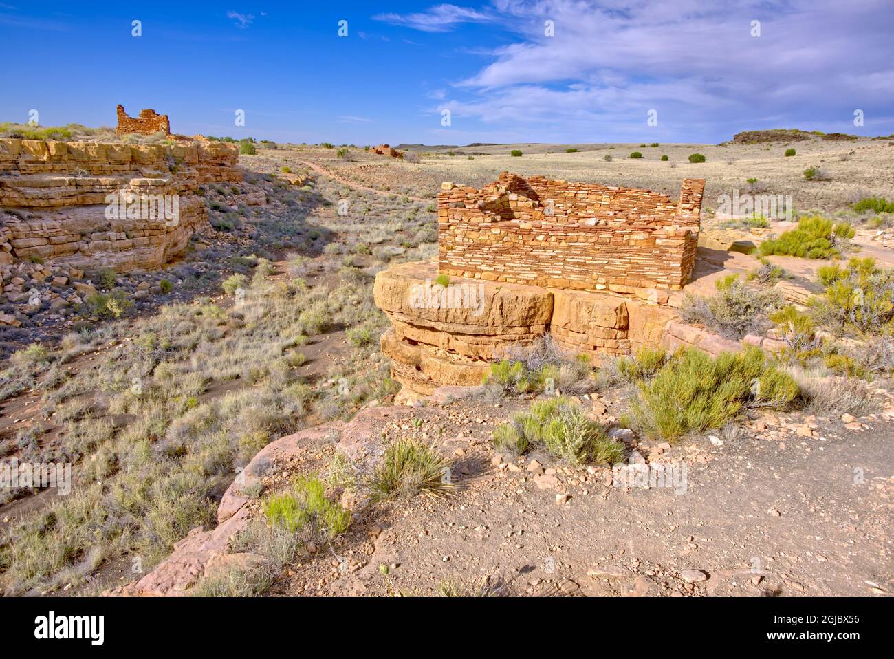 View of 2 Box Canyon Indian Dwellings with the Lomaki Pueblo in the far background. Located in the Wupatki National Monument near Flagstaff Arizona. Stock Photo