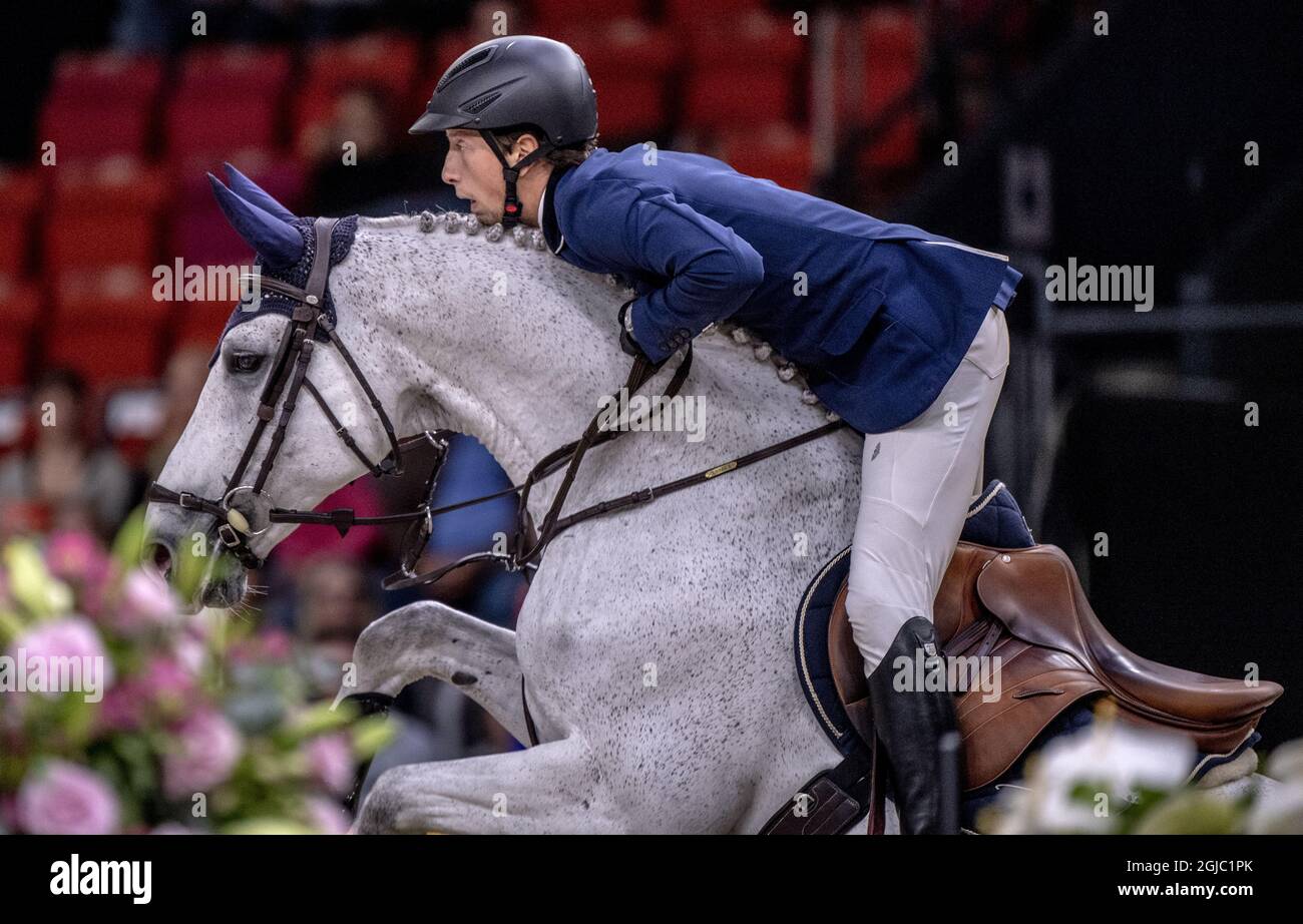 Martin Fuchs of Switzerland rides Clooney 51 during FEI World Cup final 1 show jumping event at Gothenburg Horse Show in Scandinavium Arena April 4, 2019. Photo Bjorn Larsson Rosvall / TT kod 9200 Stock Photo