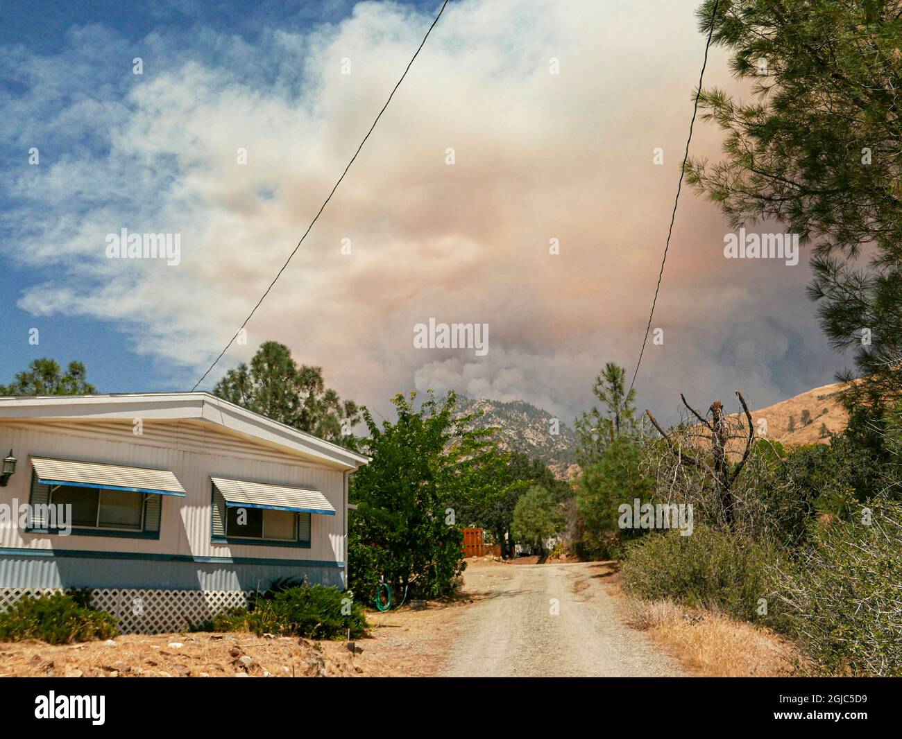 Smoke and fire clouds from wildfire at Black Mountain, homes in Wofford