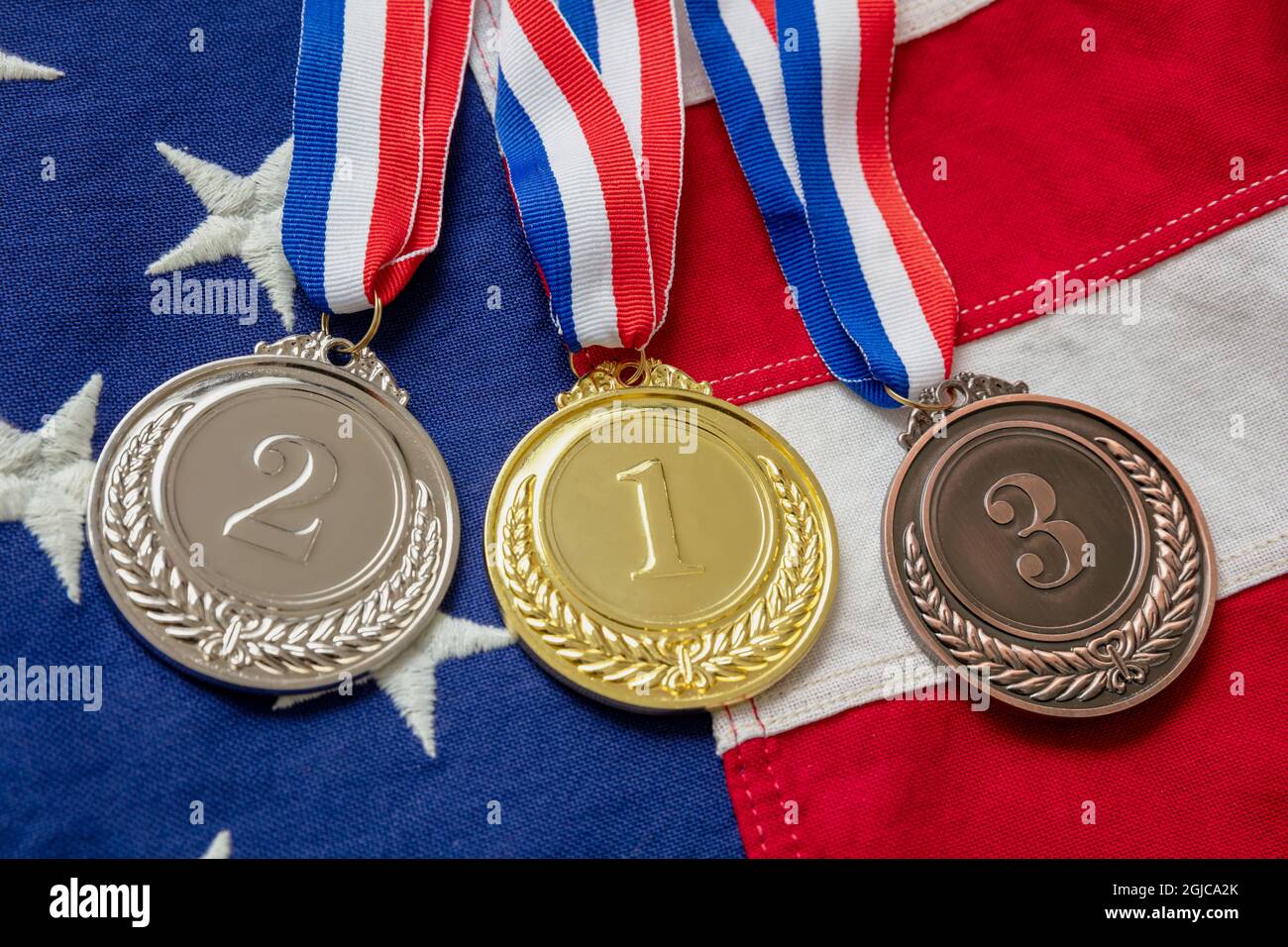 Medals set, USA flag. Gold, silver and bronze on American symbol. Winners, United States athletes podium prize trophy concept. Stock Photo