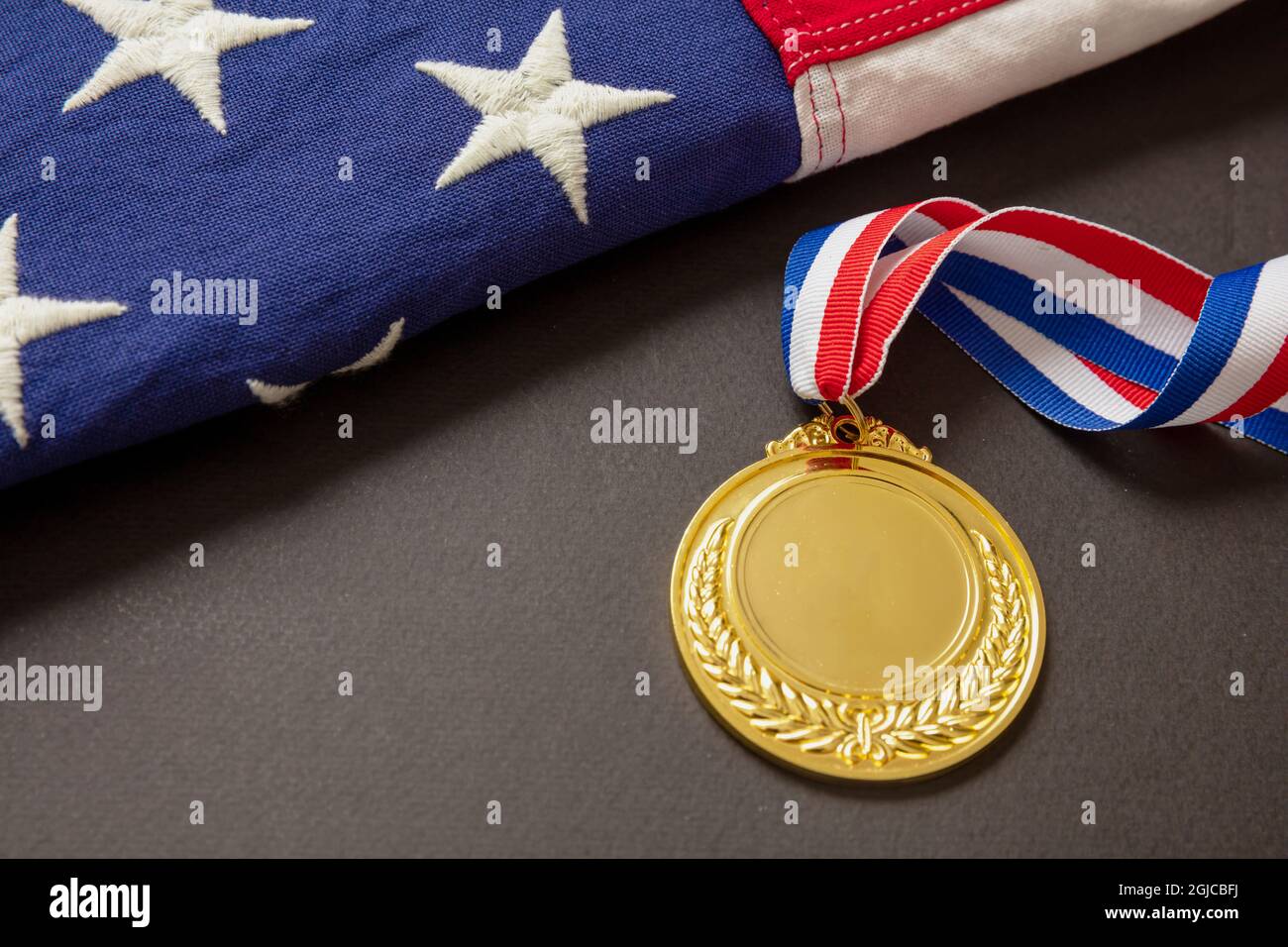 Medal gold for USA. Winner prize award with ribbon and US flag on black