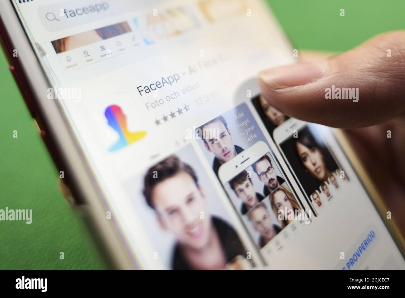 A woman is seen using the Russian mobile app Face app which render a ...