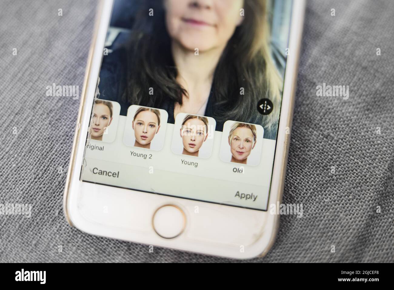 A woman is seen using the Russian mobile app Face app which render a ...