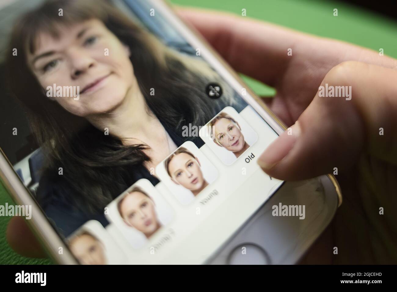 A woman is seen using the Russian mobile app Face app which render a ...