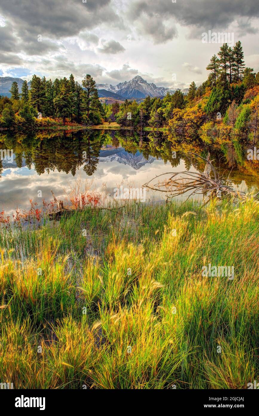 Mt. Snaffles is reflected in an autumn pond of color in the Colorado Rocky Mountains Stock Photo