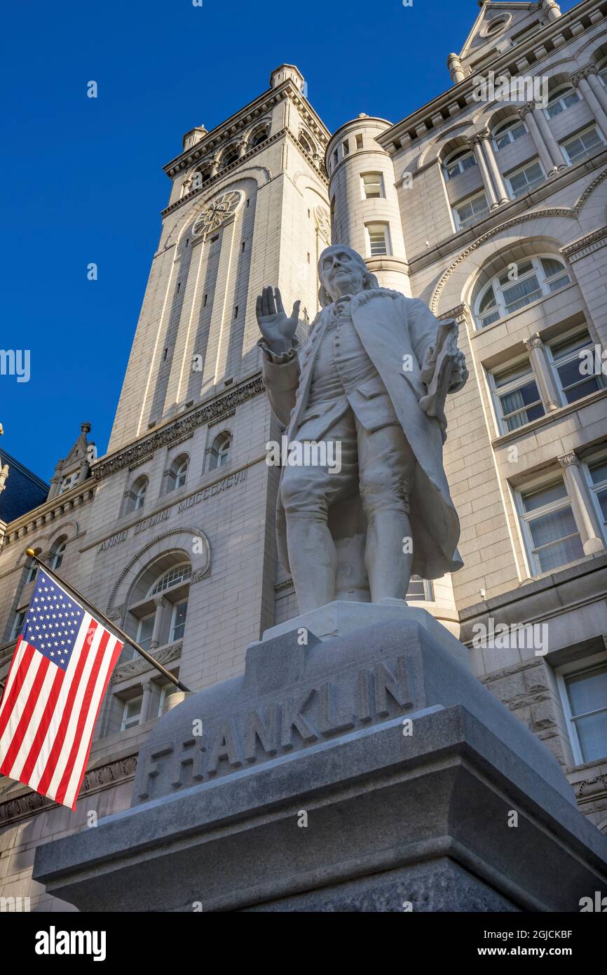 Benjamin Franklin statue, American Flags in Old Post Office building, Pennsylvania Avenue, Washington DC. Stock Photo