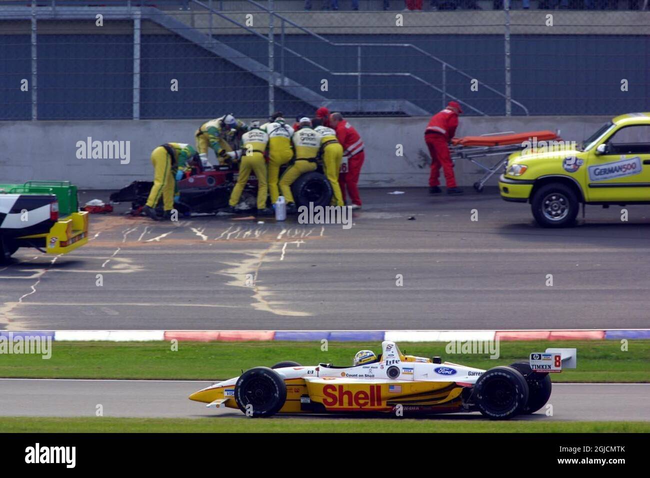 Alex Zanardi is attended to by Marshalls after he was hit by Alex Tagliani as he came out of the pits Stock Photo