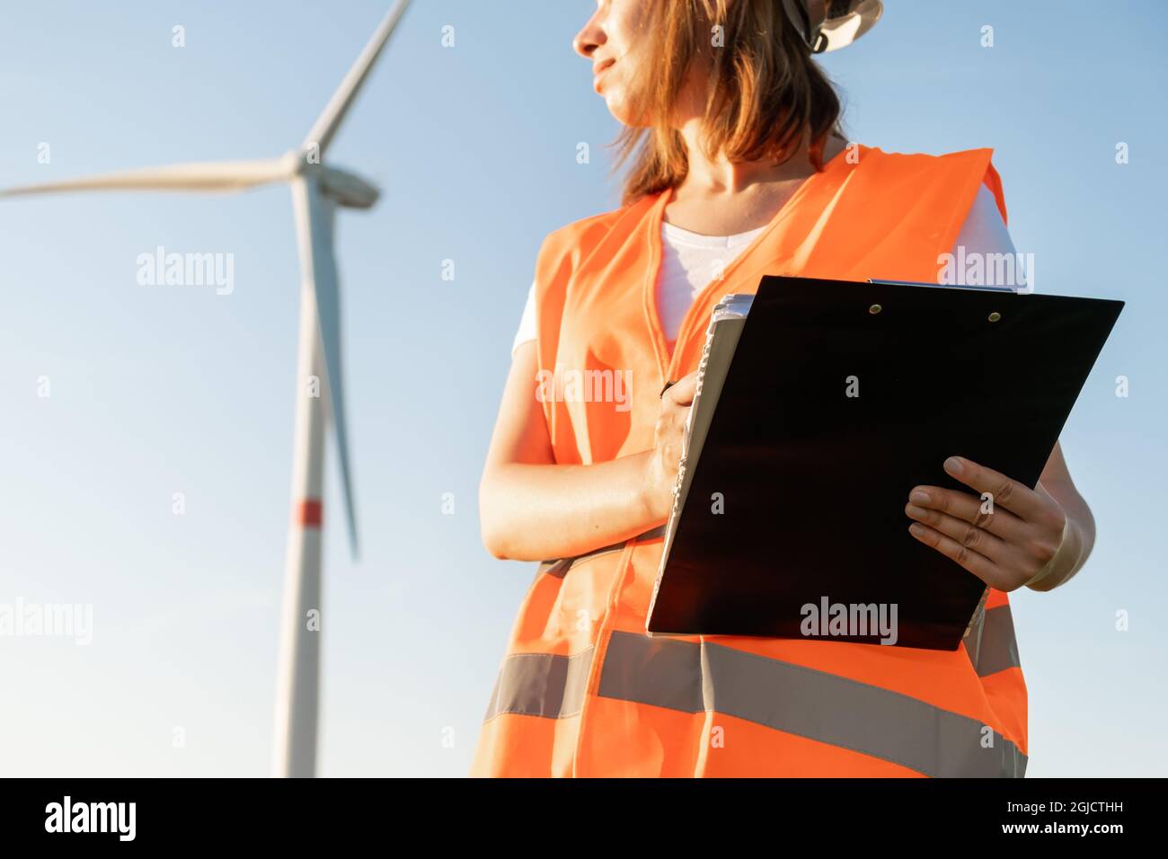 Female maintenance engineer controls the work of wind turbines and