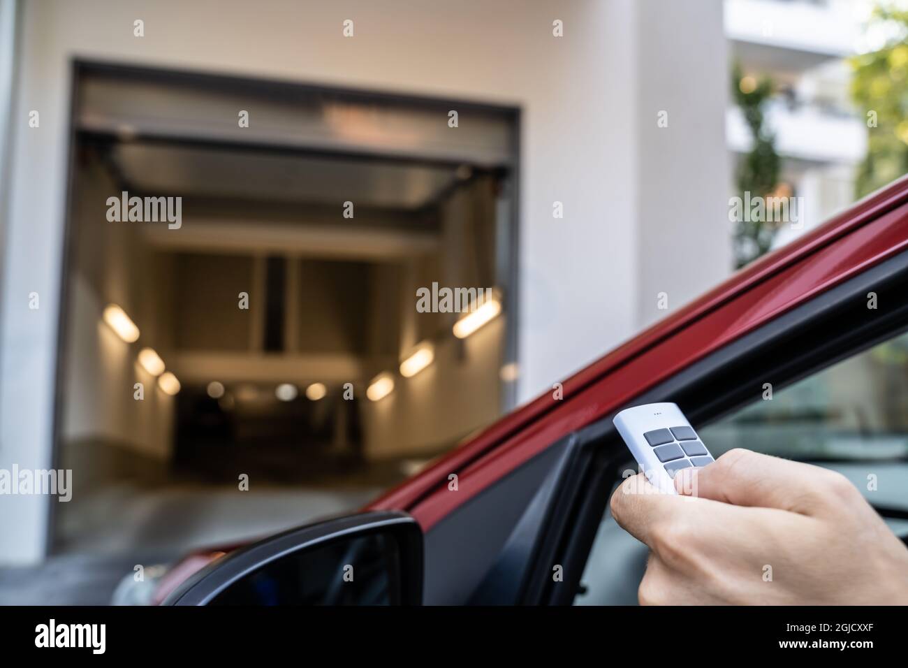Automatic Wireless Home Garage Door. Hand Using Controller In Car Stock Photo