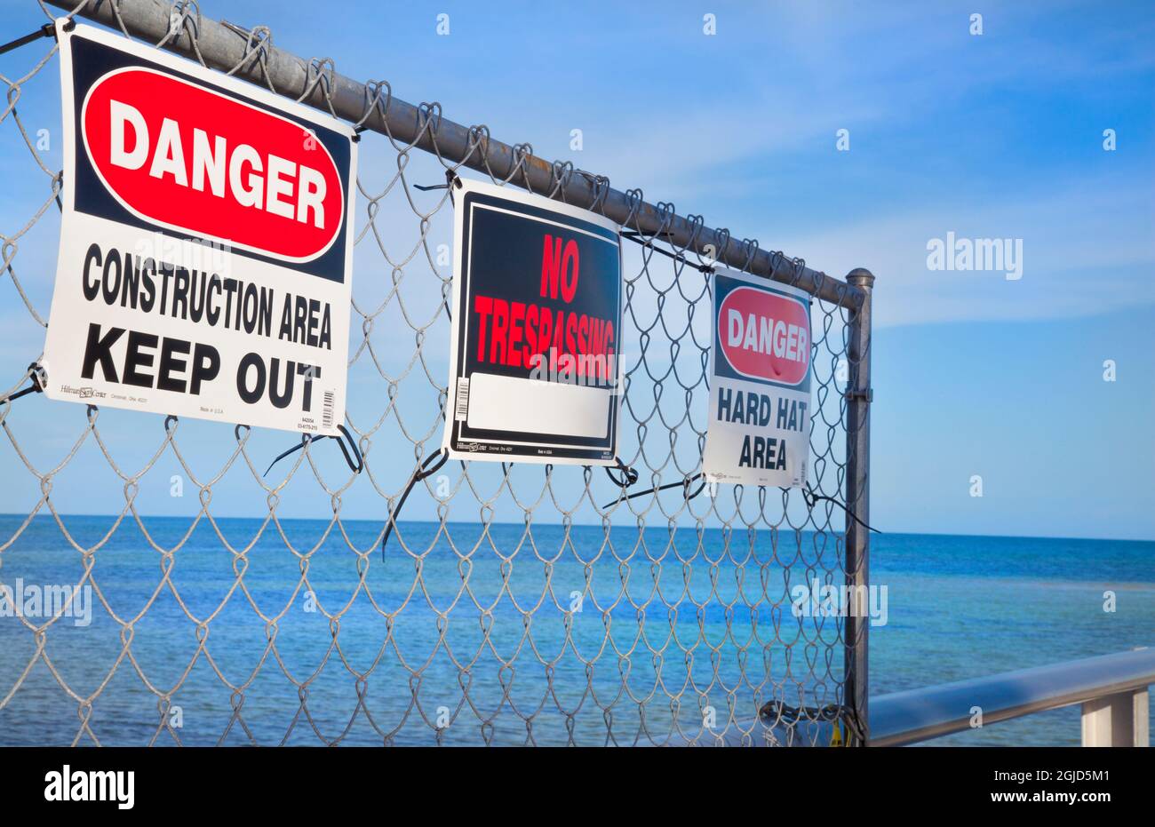 Danger 'Construction Area', 'Keep Out', 'No Trespassing' signs on pier