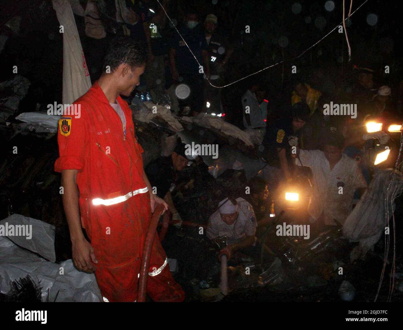 Rescue workers inside  the crashed flight OG269 at the Phuket airport in Thailand,  September 16, 2007. The passenger jet crashed at landing killing approximately 90 passengers. Stock Photo