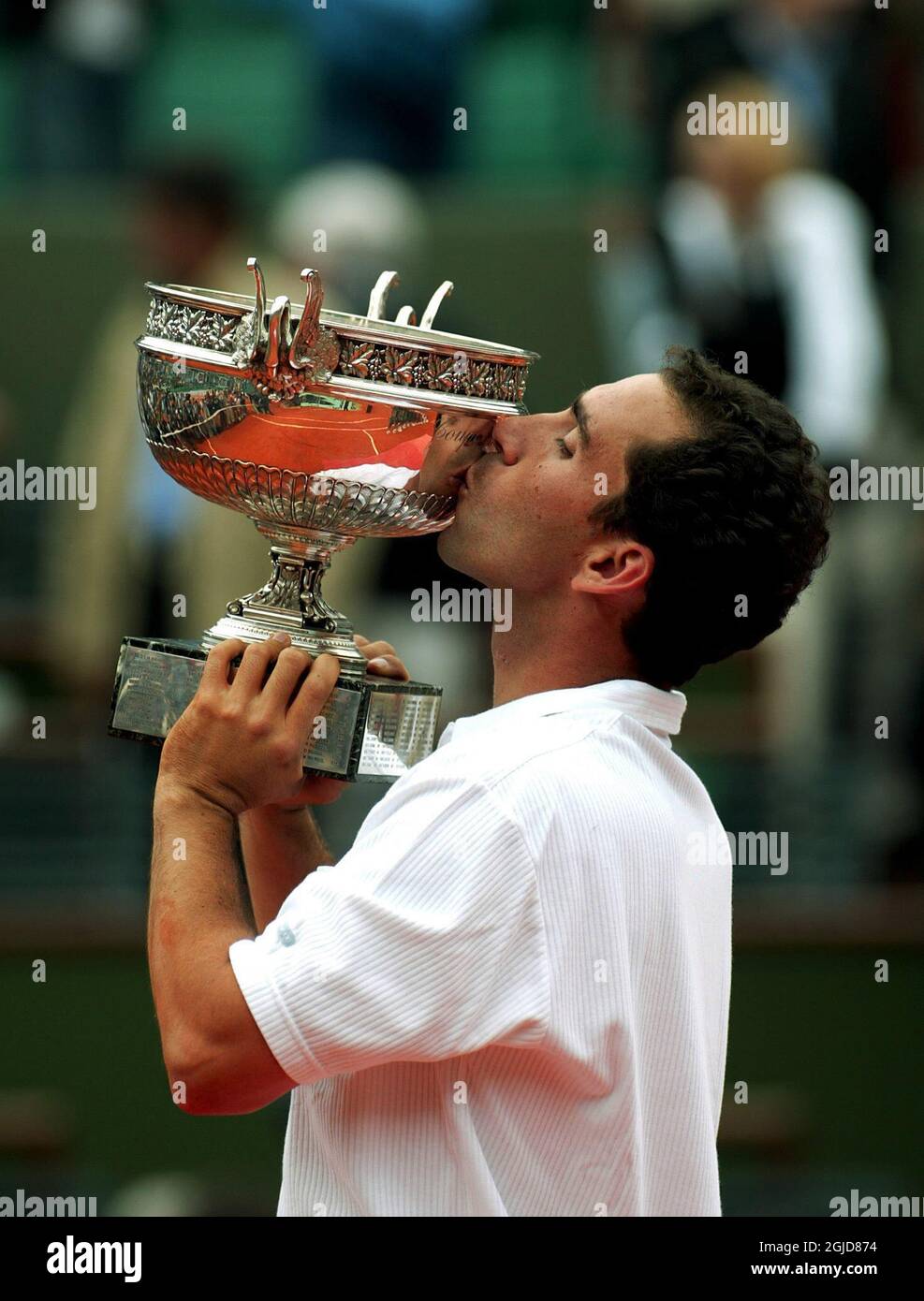 Alberto Costa of Spain kisses the French Open trophy as he celebrates victory over compatriot Juan Carlos Ferrero Stock Photo