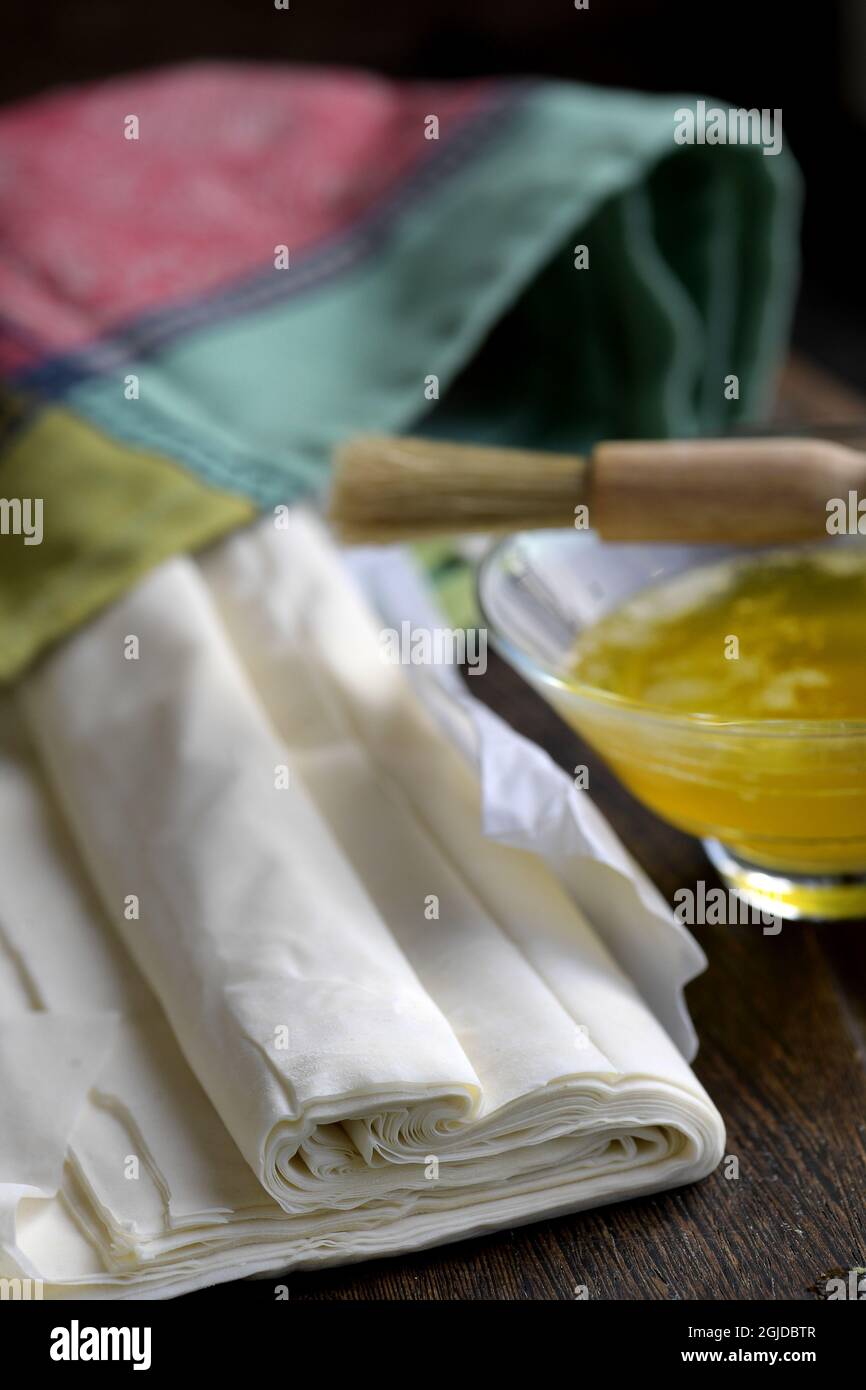Making phyllo / filo pastries and pies. Sheets of filo pastry, oil and