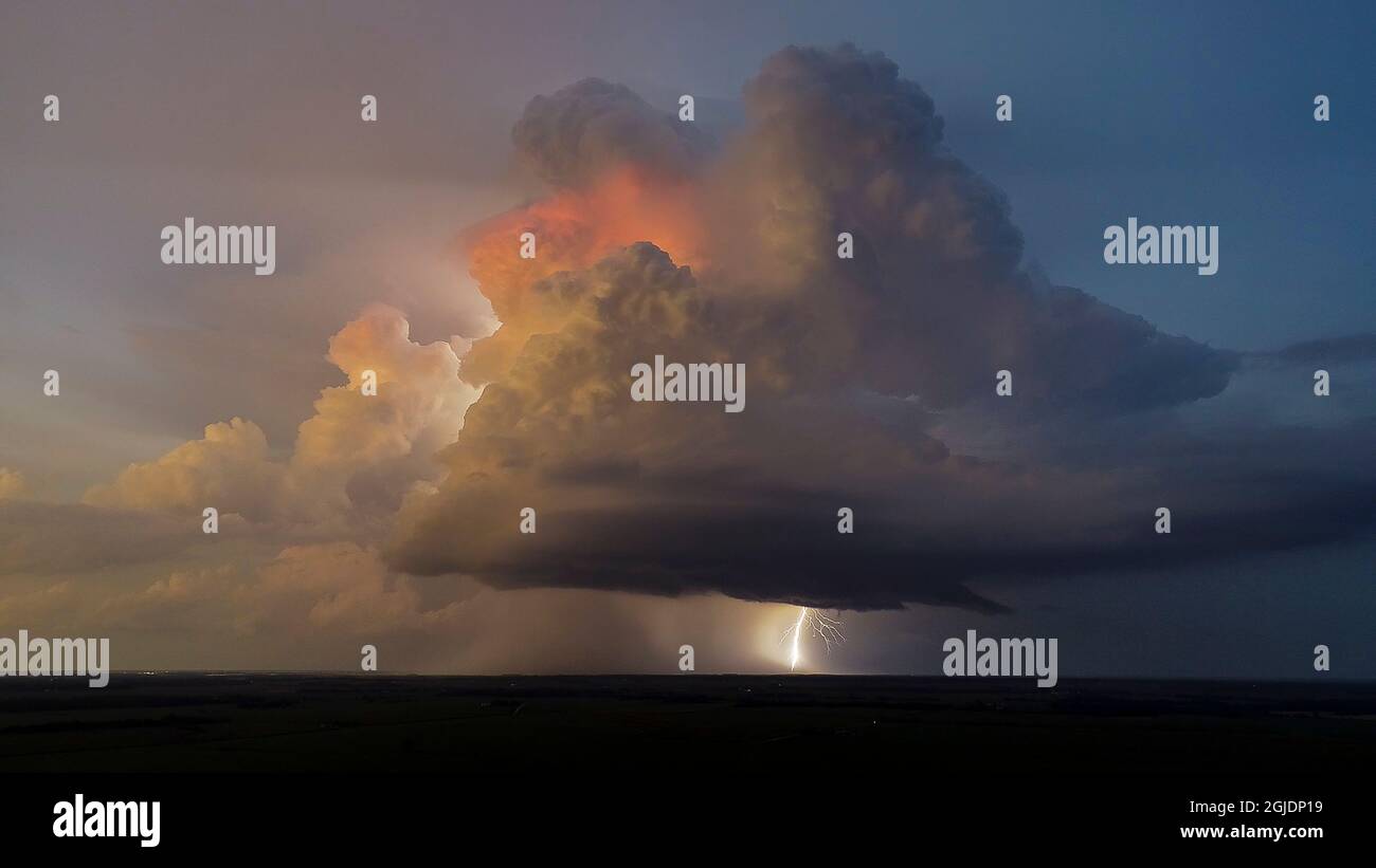 Aerial view of thunderstorm clouds and lightning at sunset, Marion ...