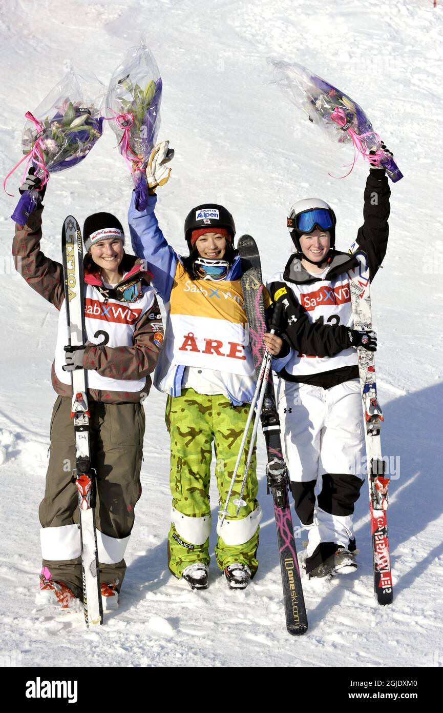 Podium from left, Nikola Sudova, Czech Republic second place, Aiko Uemura, Japan, first place and Kayla Snyderman, USA, third place after the Freestyle Skiing Ladies' Dual Moguls Final event in Are, Sweden. Stock Photo