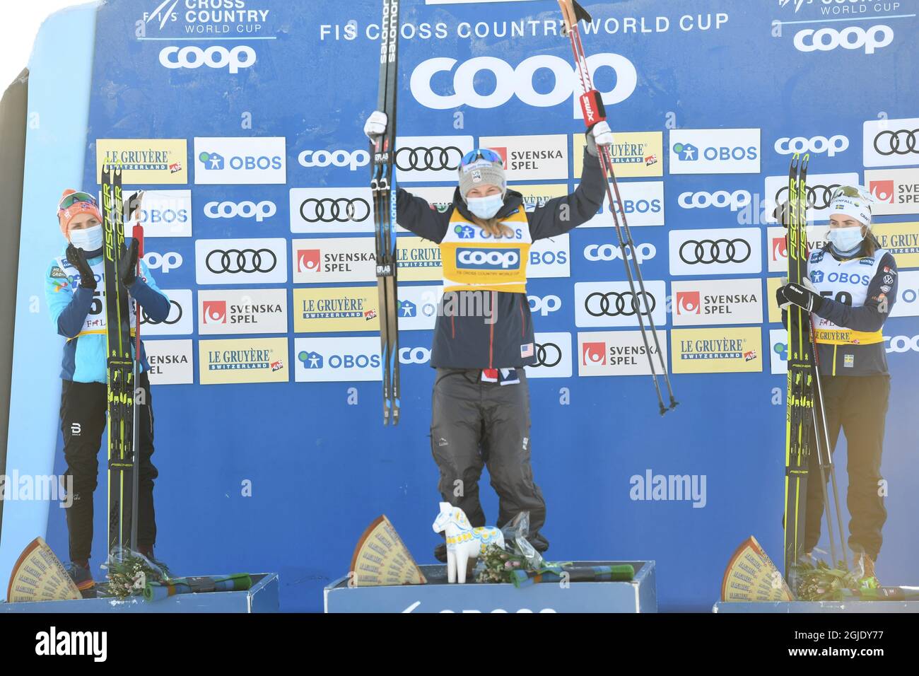 Jessie Diggins of the US (center) wins, Therese Johaug of Norway (left) placed second and Ebba