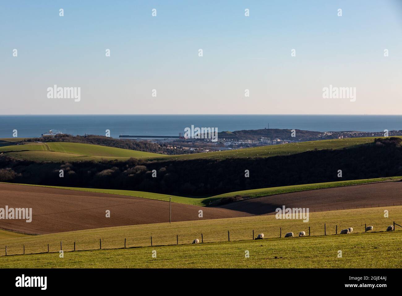 The view over farmland from Firle Beacon, with Newhaven and the ocean in the distance Stock Photo