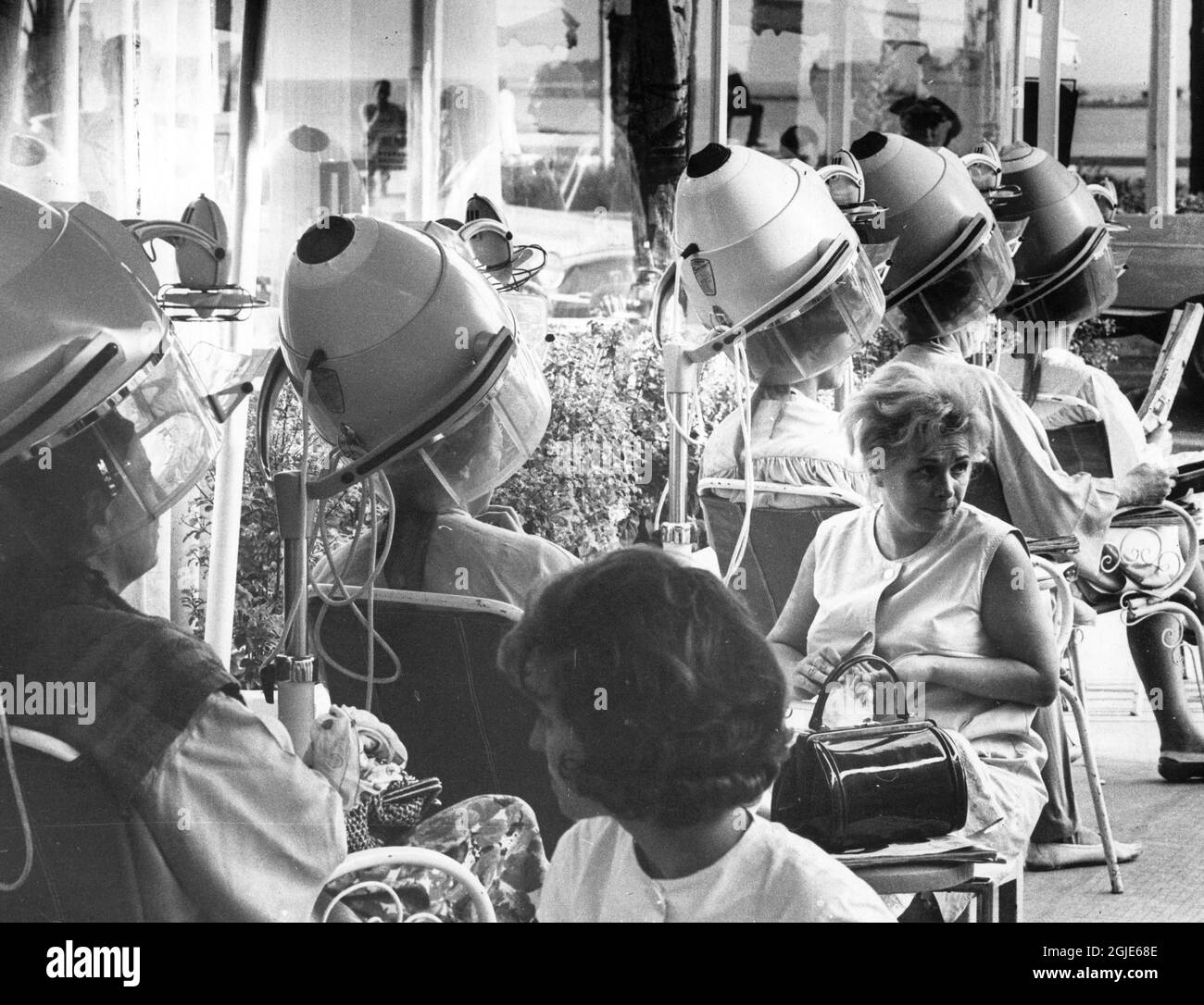 Women getting their hair dried at a hairdresser's in Cannes, France
