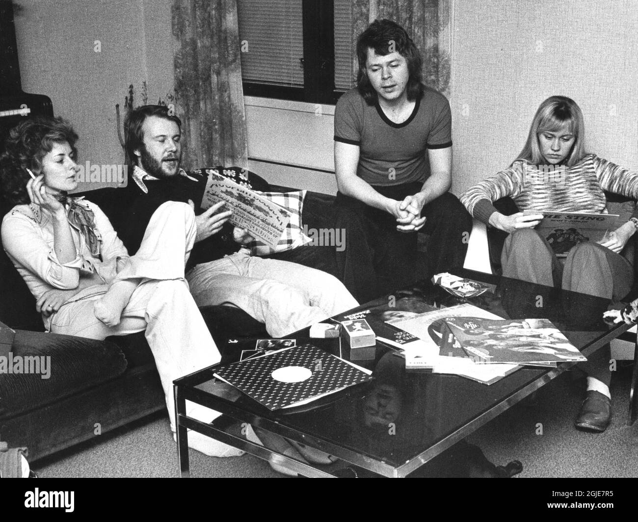 Anni-Frid Lyngstad, Benny Andersson sitting in a sofa, smoking and listening to records in Bjorn Ulvaeus and Agnetha Faltskog's apartment in Stockholm, Sweden, March 27, 1974. Photo: Jonny Graan / Expressen / TT / code 16  Stock Photo