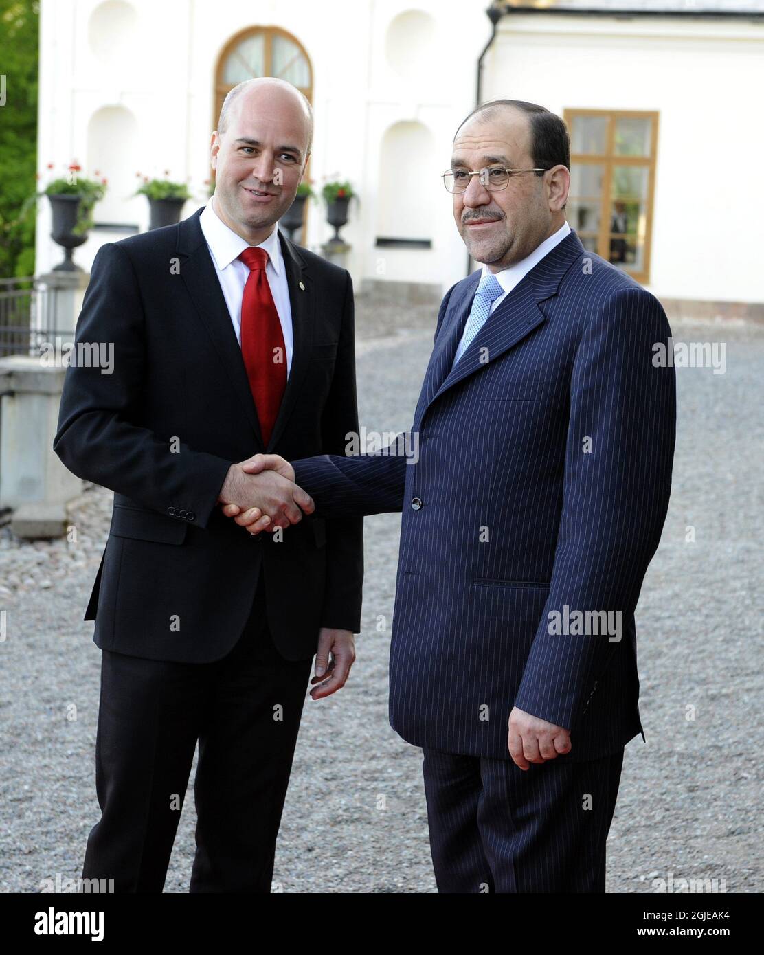 Sweden's Prime Minister Fredrik Reinfeldt (L) welcomes the Iraqi Prime Minister Nouri al-Maliki to a reception at Rosersberg Palace at the end of the first annual review of the International Compact with Iraq in Stockholm. Stock Photo