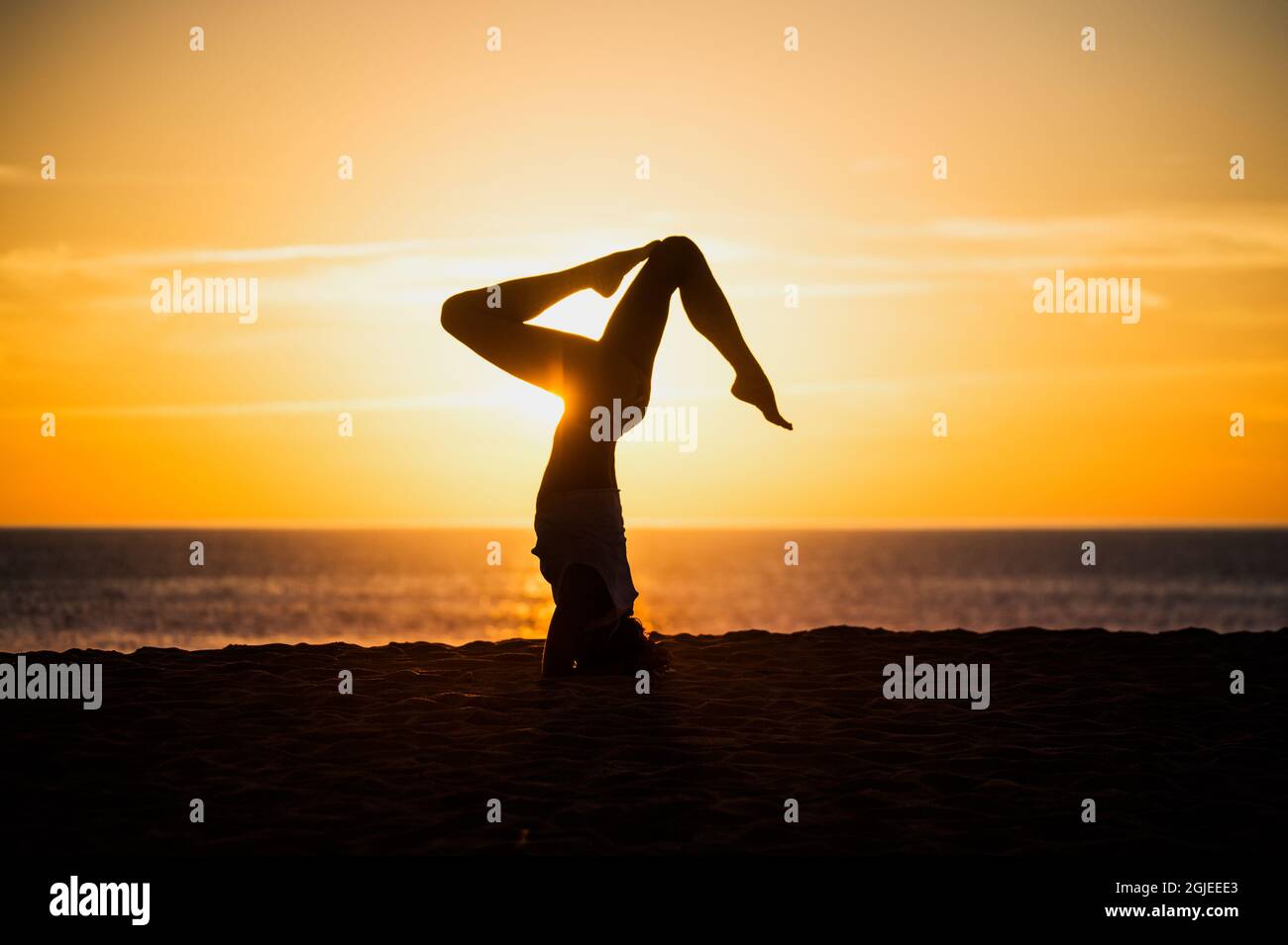 Woman doing yoga on a beach in the sunset. Photo: Evelina Ronnback/Bildhuset/TT code 8181  Stock Photo