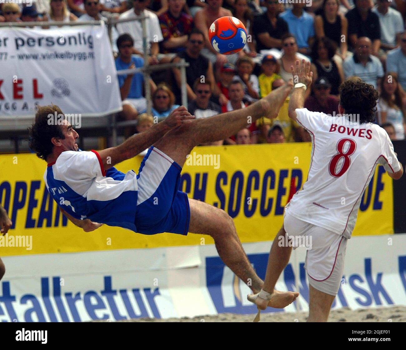 Former Manchester United player Eric Cantona (l) attempts a bicycle kick as England's Terry Bowes (r) closes him down Stock Photo