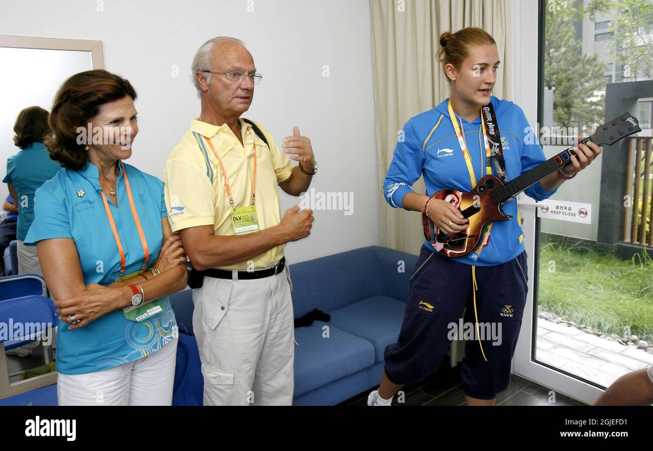 The Swedish king Carl Gustaf and queen Silvia learns the hot points of the Guitar Hero game from Taekwondo athlete Karolina Kedzierska. Stock Photo