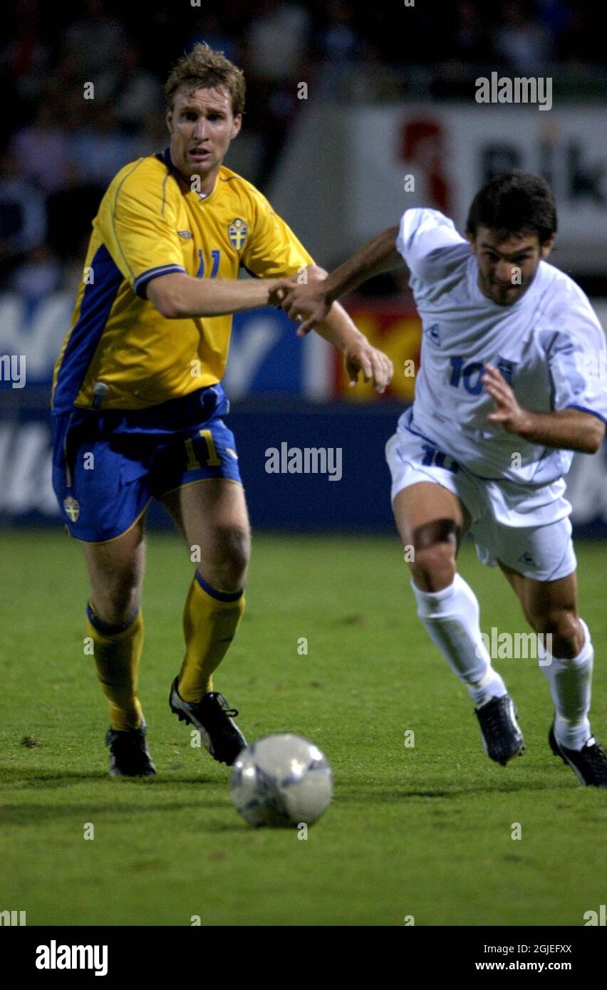 Sweden's Niklas Skoog (l) chases the ball with Greece's Georgios Karagounis (r) Stock Photo